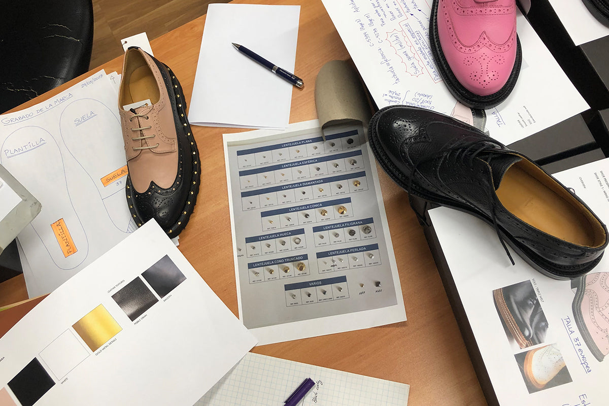 shoe samples and papers scattered all over work table